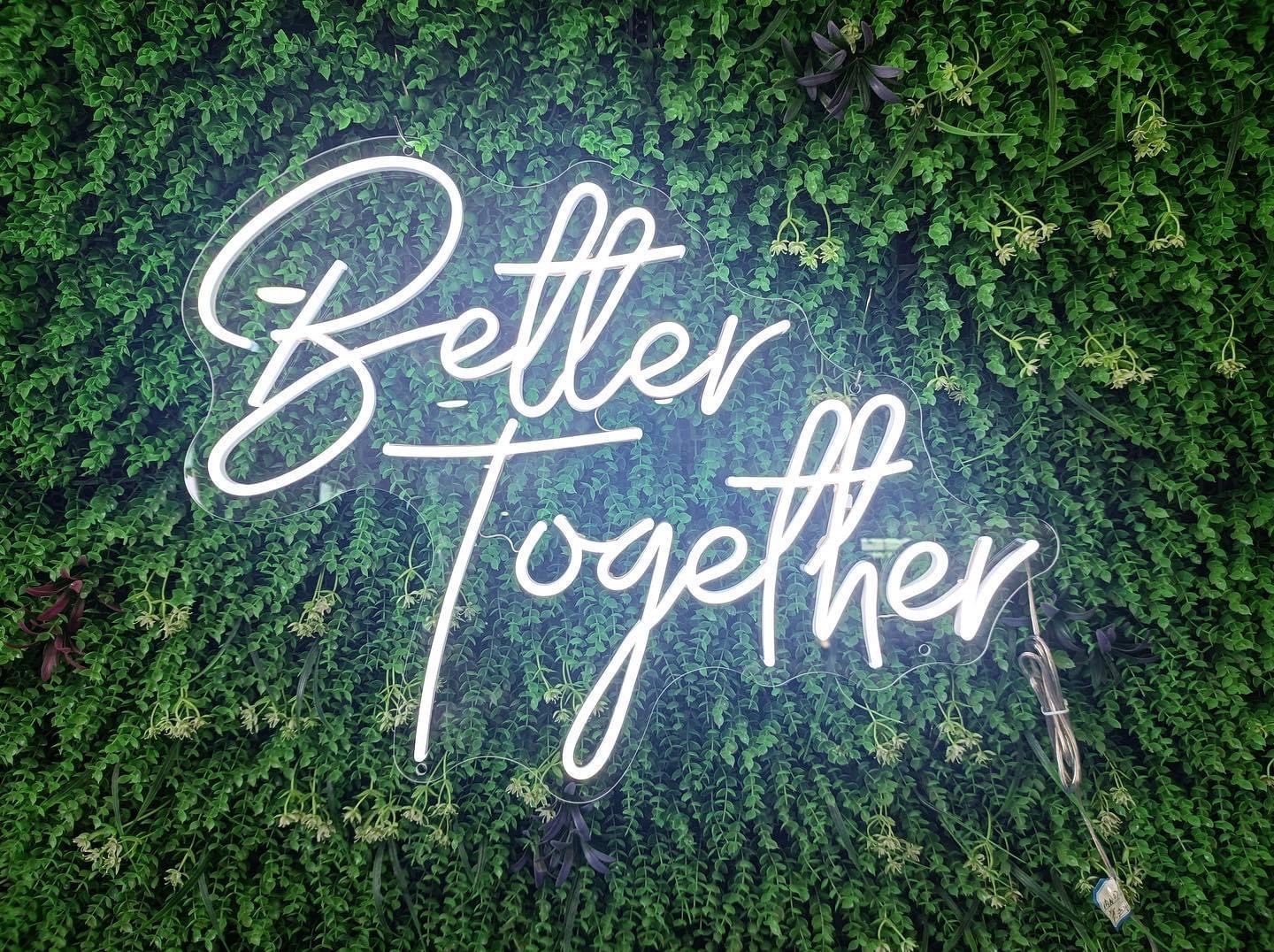Better Together neon on greenery wall